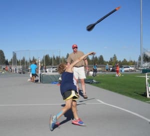 A YOUNG JAVELIN THROWER TESTS HIS ARM DURING THE OPEN TRACK AND FIELD MEET.