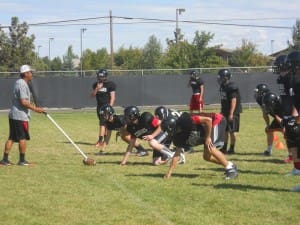 DEFENSIVE COORDINATOR NEIL ELSHIRE WORKING WITH THE COUGARS D-LINE.