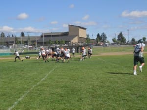 KADEN WADSWORTH RUNS A ROUTE AT SUMMIT HIGH'S PRACTICE.