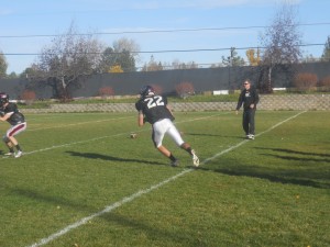 DANTLY WILCOX CUTS UPFIELD AS WR COACH WAYNE PURCELL LOOKS ON
