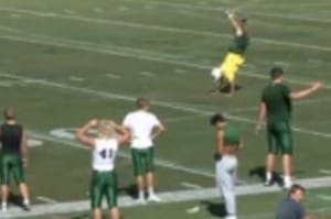 Coach Joe Padilla demonstrates proper cartwheel technique to the team. 