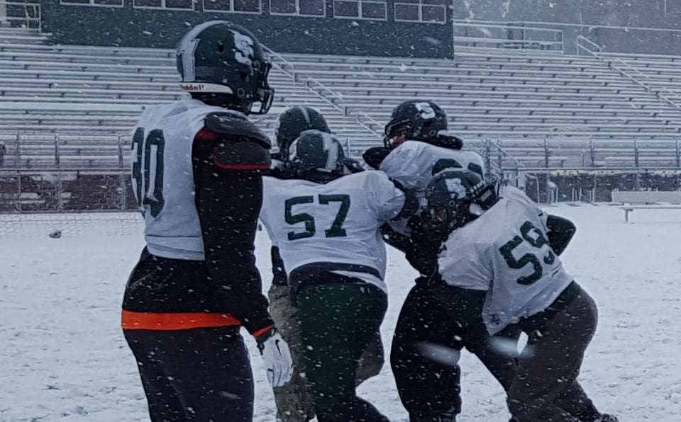 FB- SUM - The O-Line practice bull rushing in the snow 112415